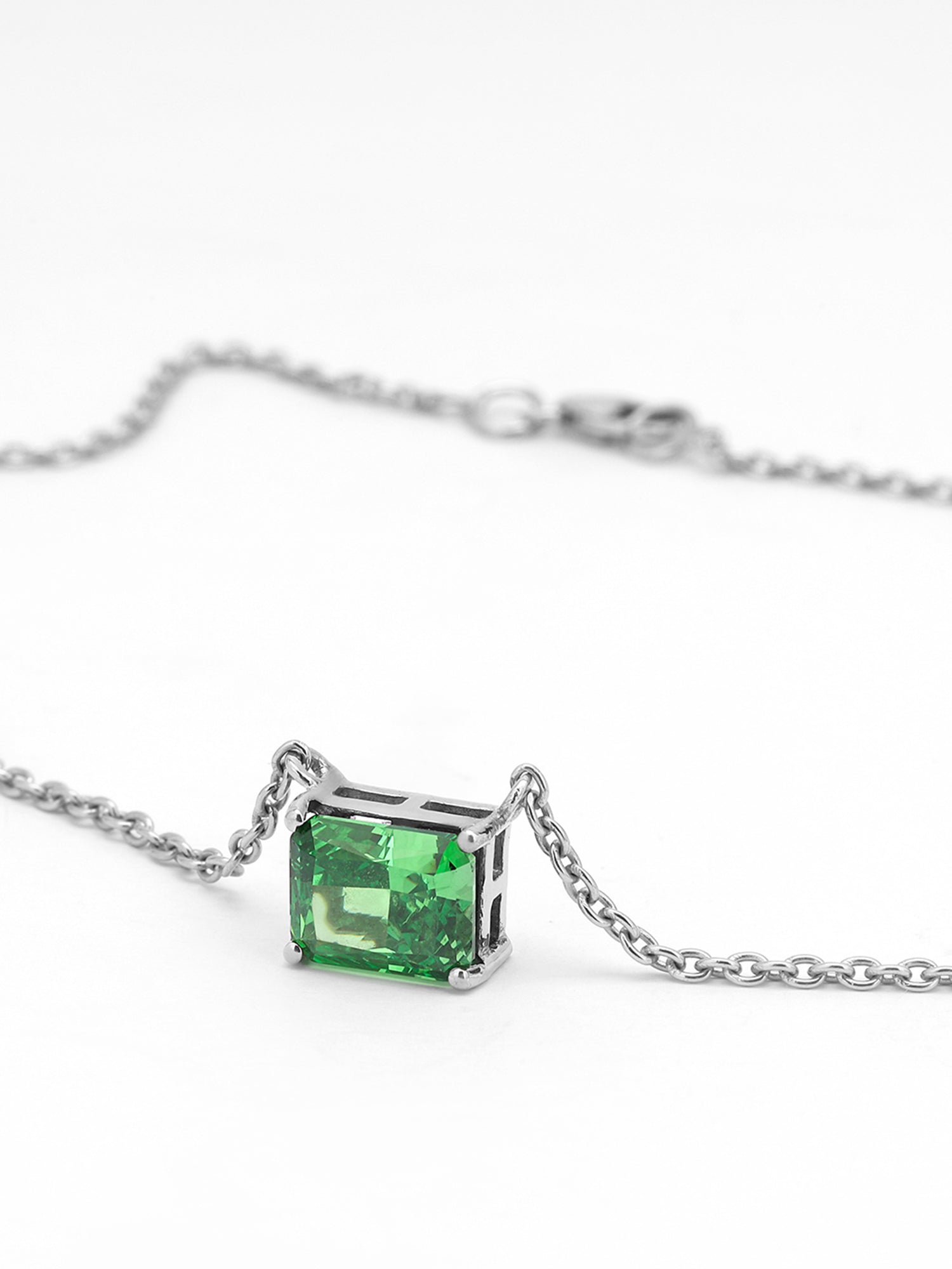 Timeless solitaire pendant with a emerald-cut gemstone in a prong setting.