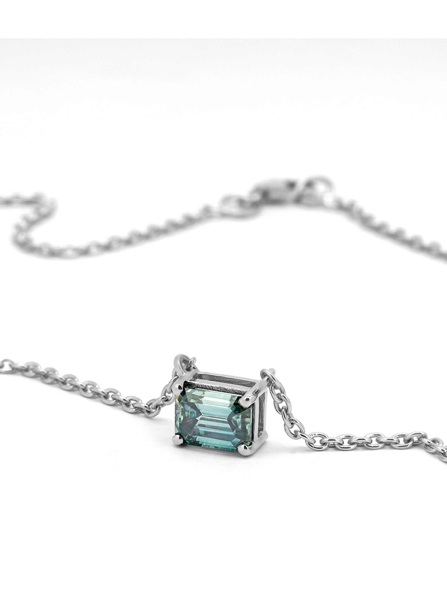 Timeless solitaire pendant with a emerald-cut gemstone in a prong setting.