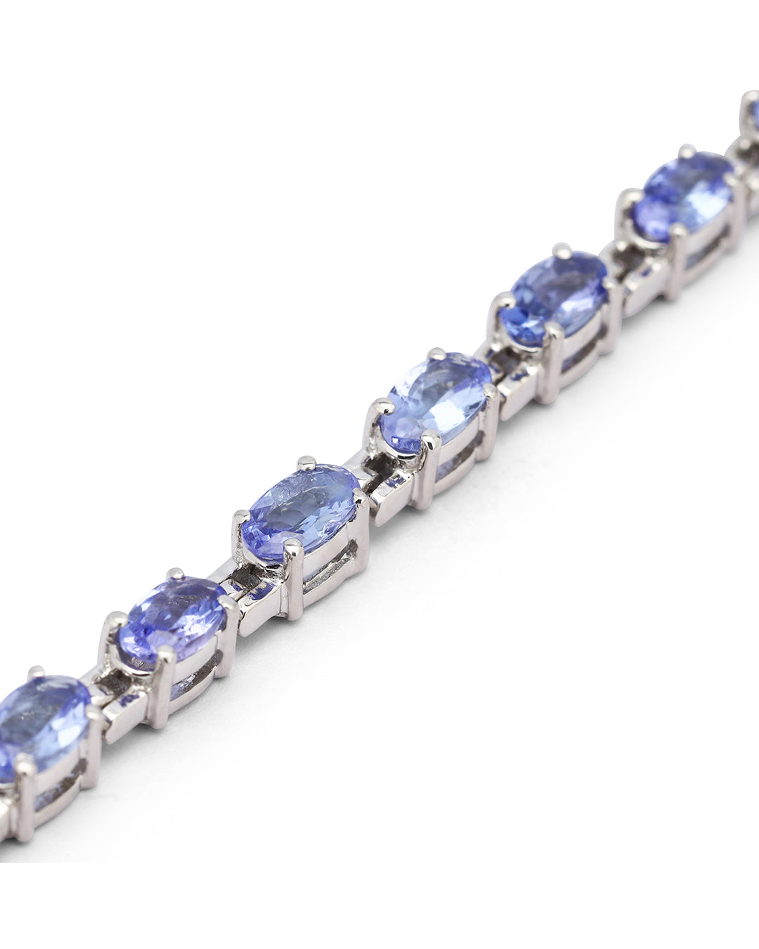 Elegant tennis bracelet with round-cut gemstones in fine metal.