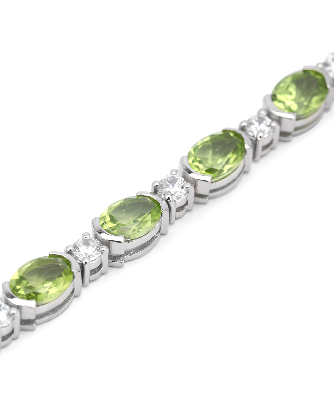 Elegant tennis bracelet with oval-cut gemstones in fine metal.