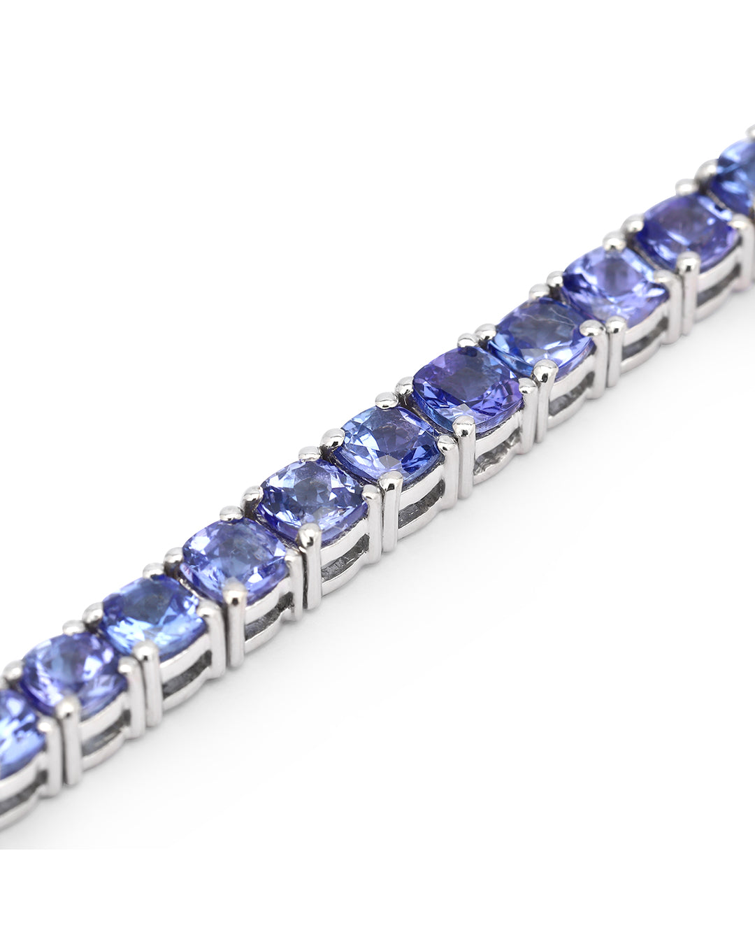 Elegant tennis bracelet with cushion-cut gemstones in fine metal.