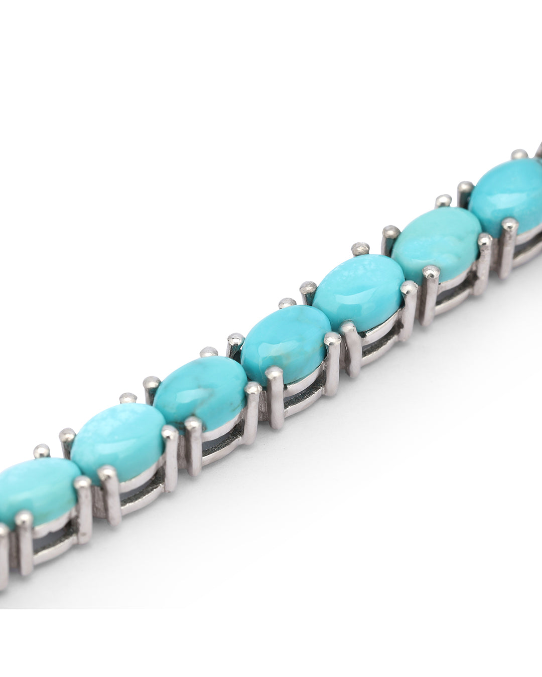Elegant tennis bracelet with oval-cut gemstones in fine metal.