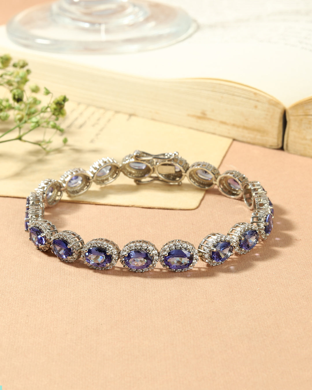 Elegant Halo link bracelet with oval-cut gemstones in fine metal.
