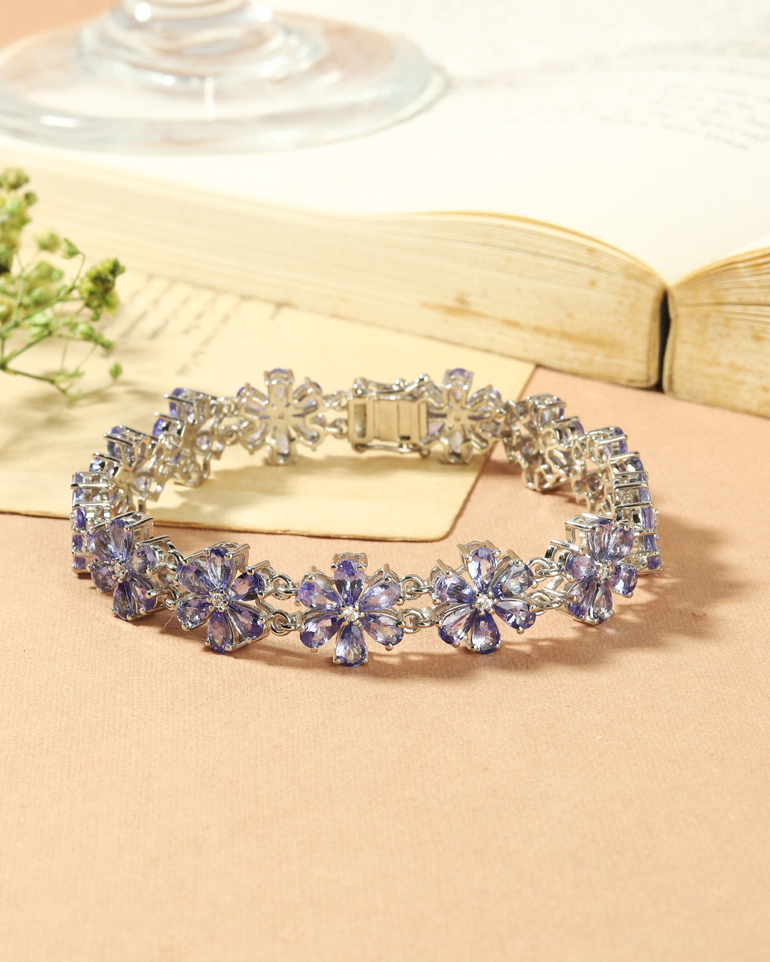 Elegant floral bunch bracelet with pear-cut gemstones in fine metal.