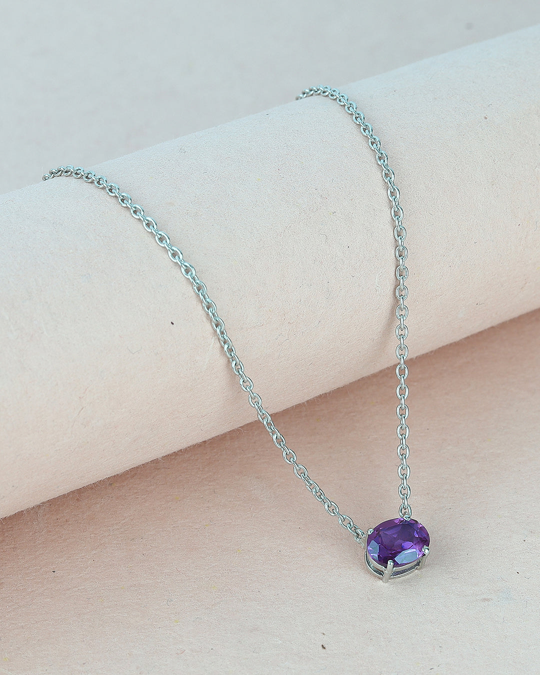Timeless solitaire pendant with a oval-cut gemstone in a prong setting.