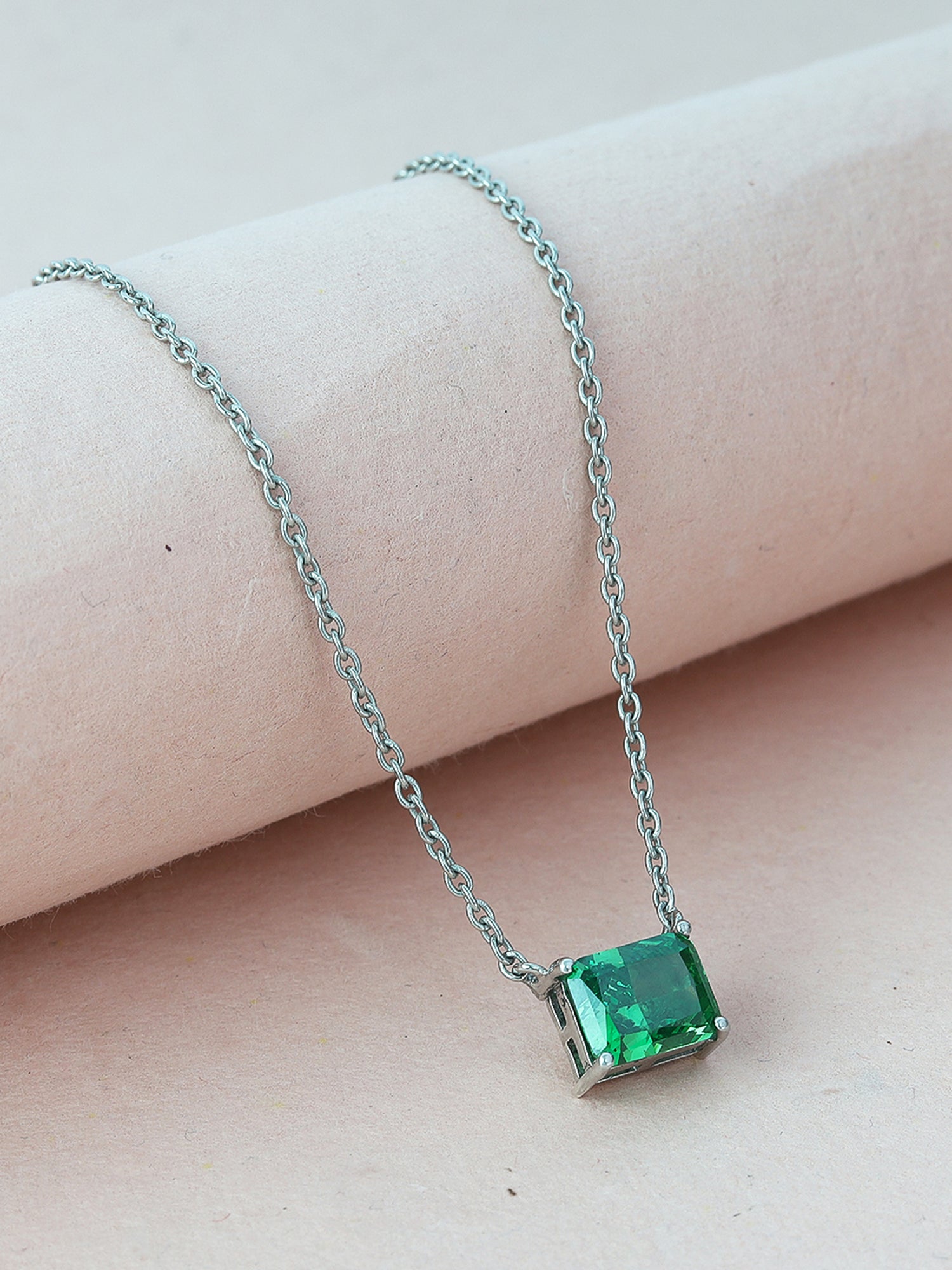 Timeless solitaire pendant with a emerald-cut gemstone in a prong setting.