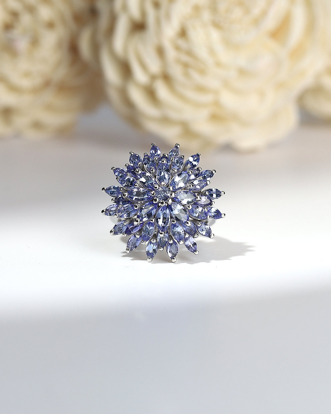 Elegant gemstone ring in sterling silver with intricate detailing.