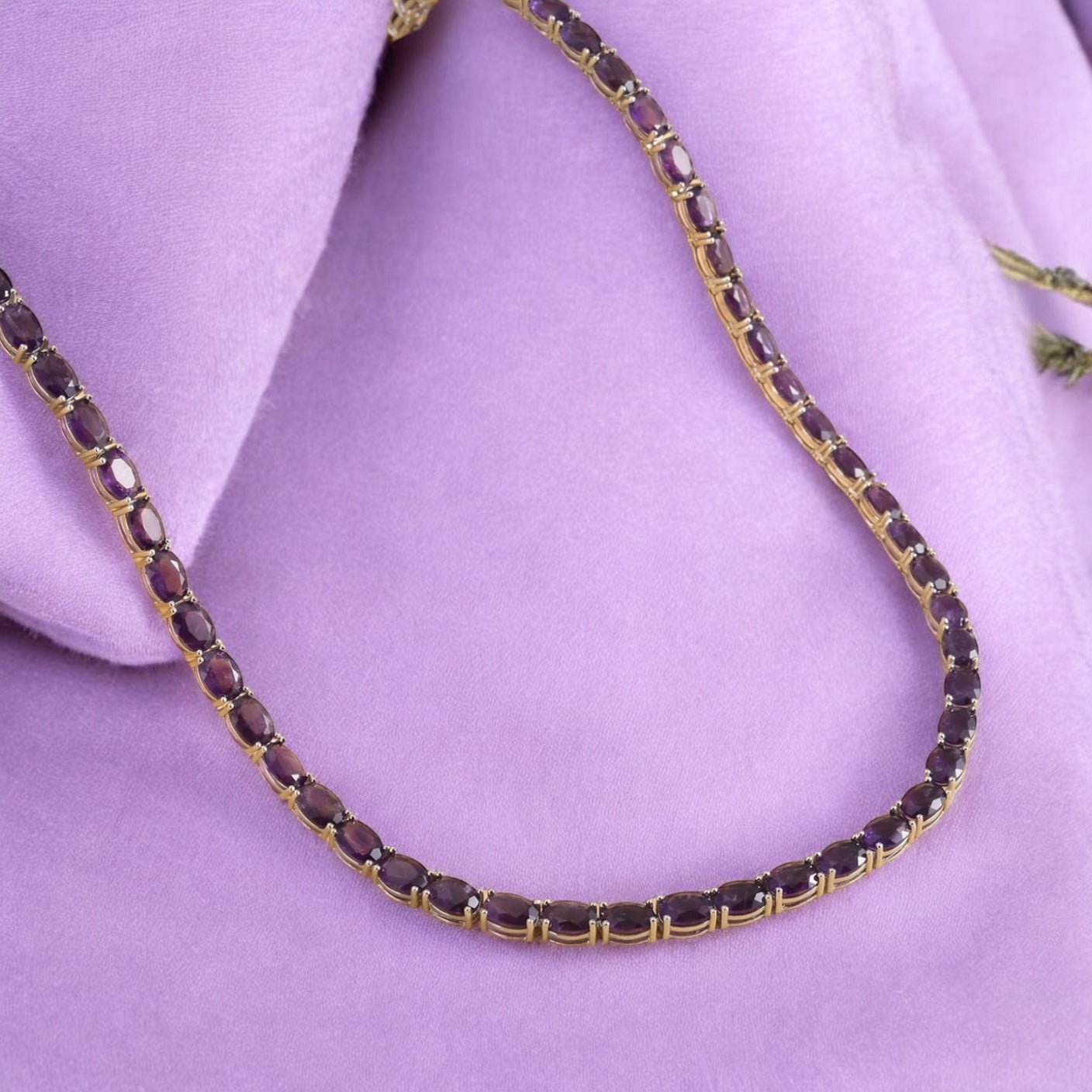 Luxury tennis necklace with sparkling gemstones set in silver.