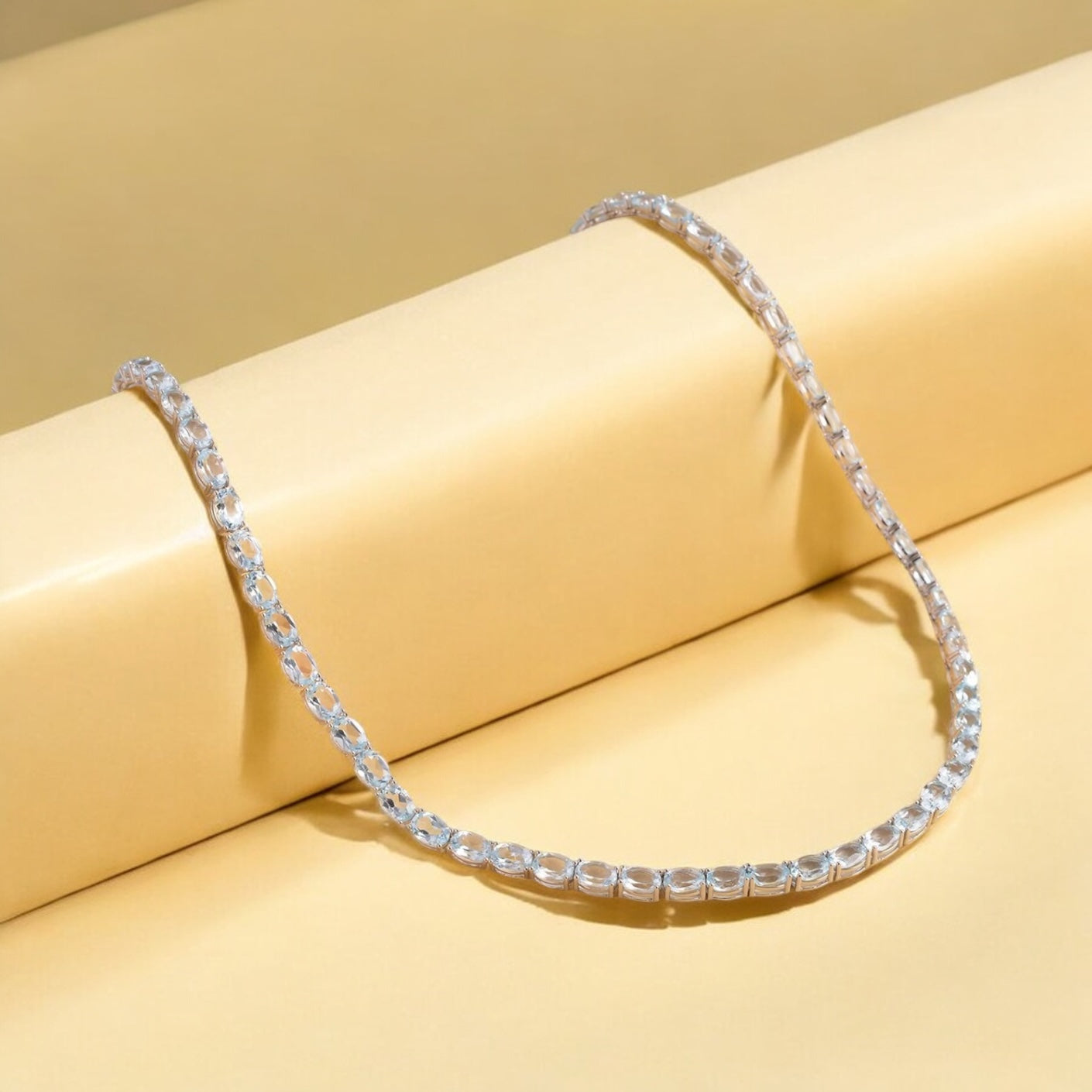 Luxury tennis necklace with sparkling gemstones set in silver.