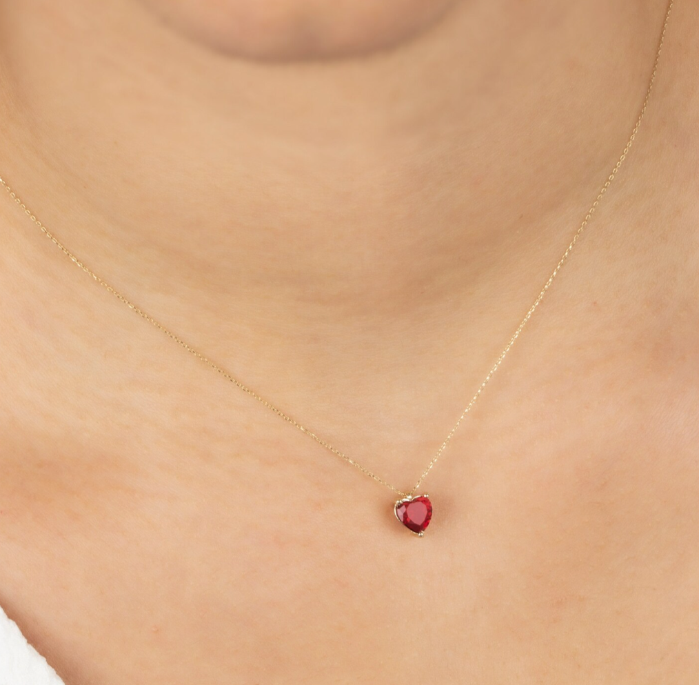 Minimalist gold chain necklace with a delicate pendant.