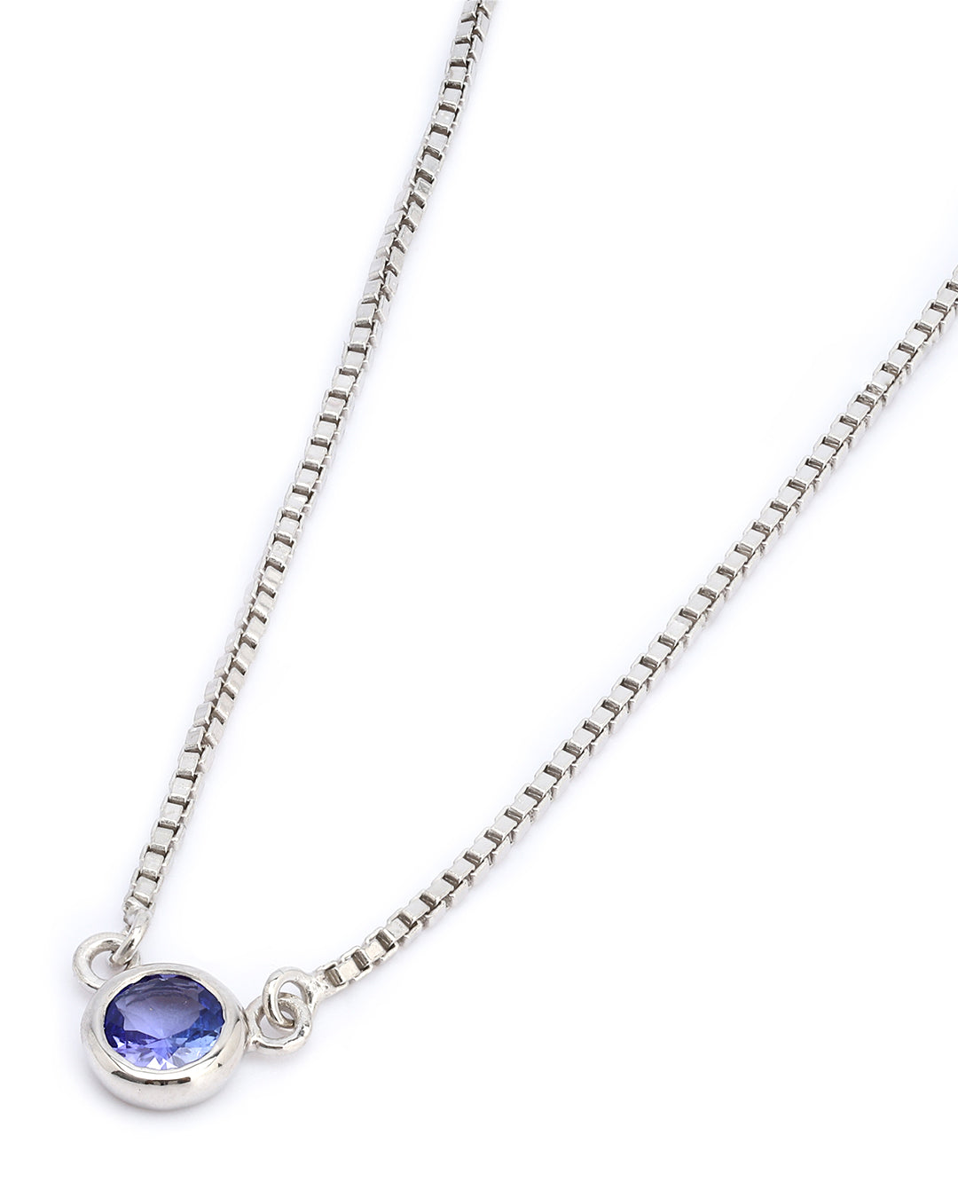 Timeless solitaire pendant with a round-cut gemstone in a prong setting.