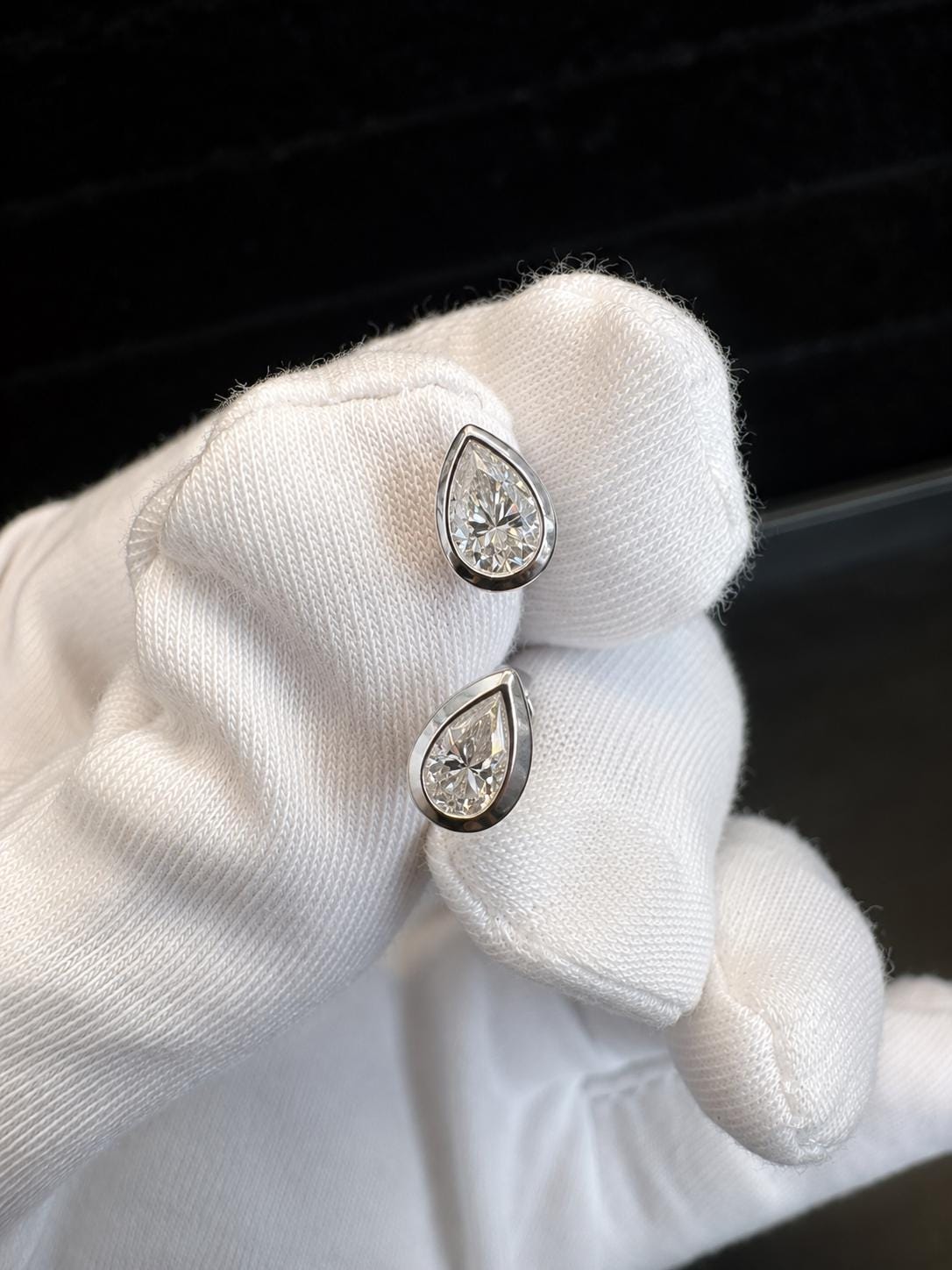 Pear Cut Moissanite Stud Earrings | Platinum Sterling Silver Bezel Set