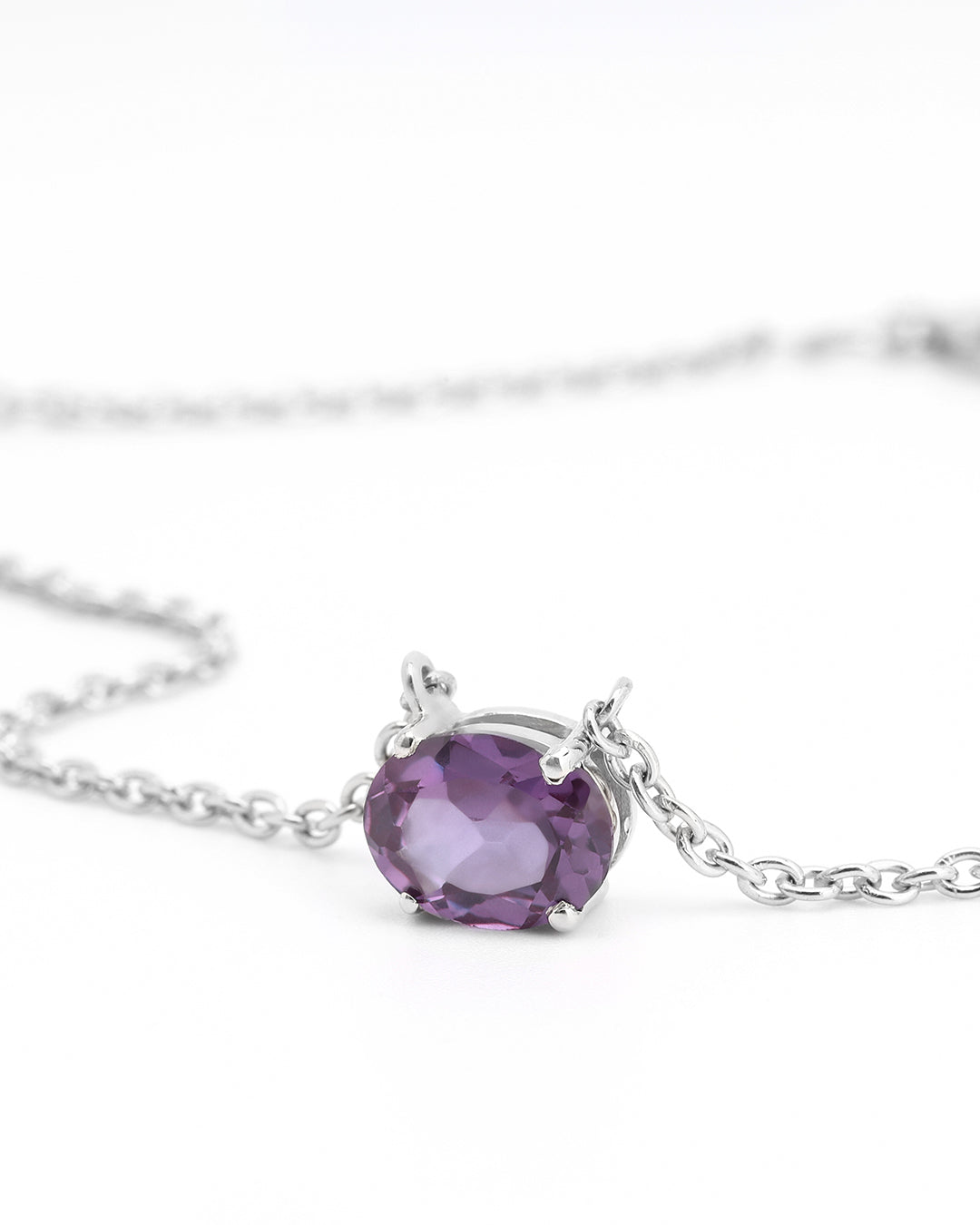 Timeless solitaire pendant with a oval-cut gemstone in a prong setting.