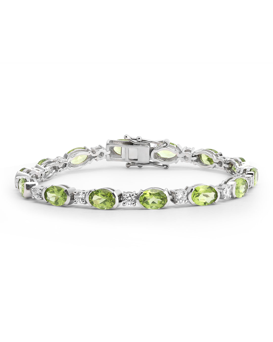Elegant tennis bracelet with oval-cut gemstones in fine metal.