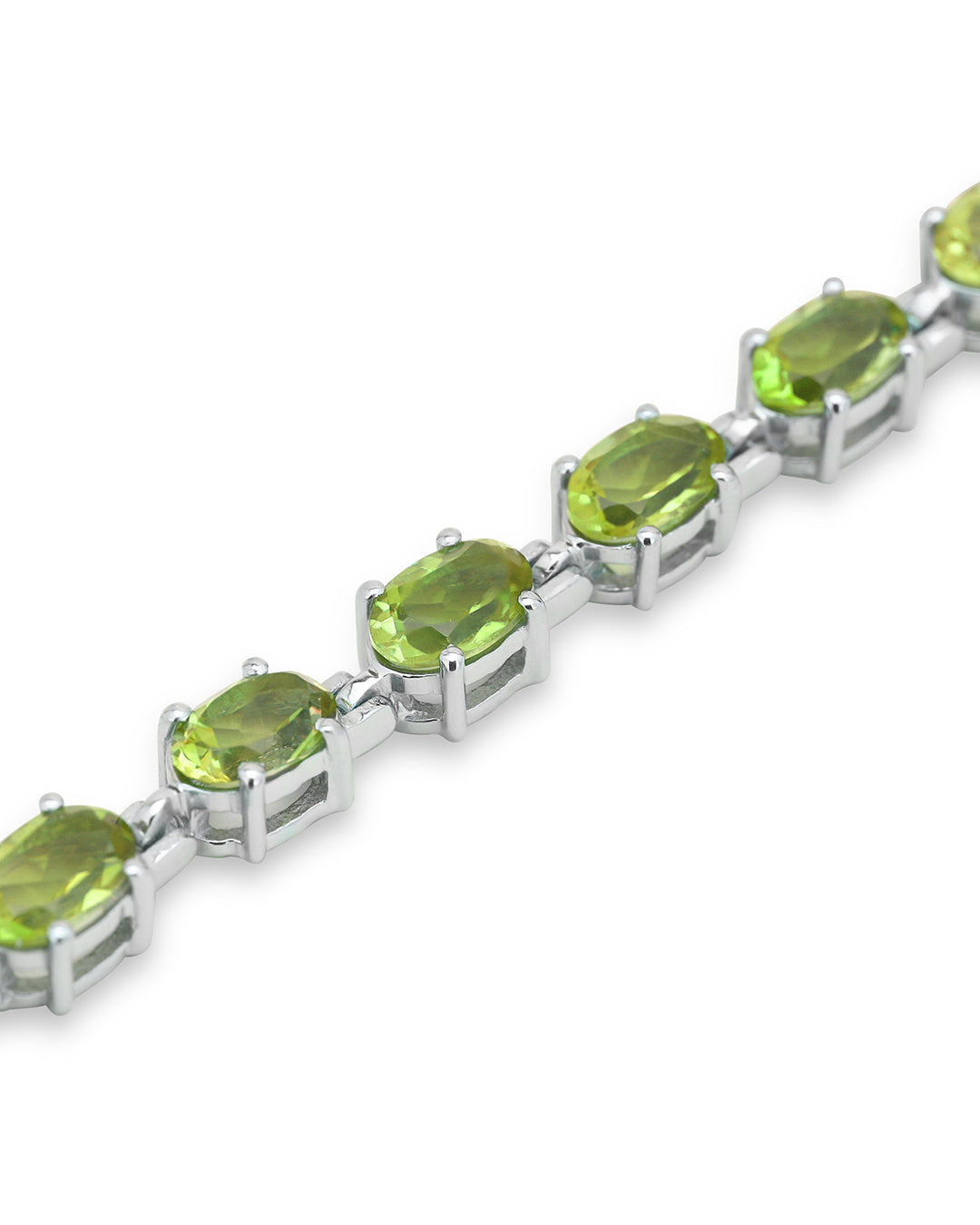 Elegant tennis bracelet with oval-cut gemstones in fine metal.