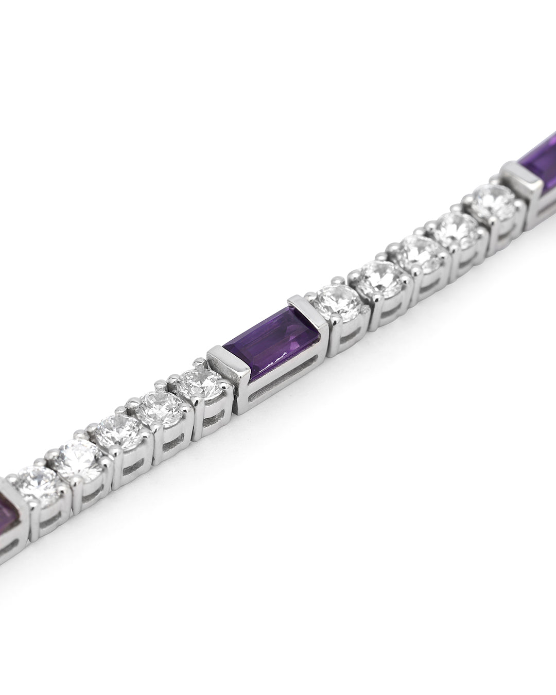 Elegant tennis bracelet with round-cut gemstones in fine metal.