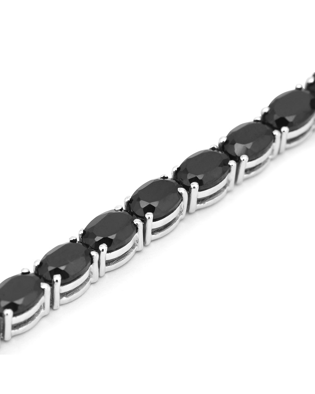 Elegant tennis bracelet with oval-cut gemstones in fine metal.