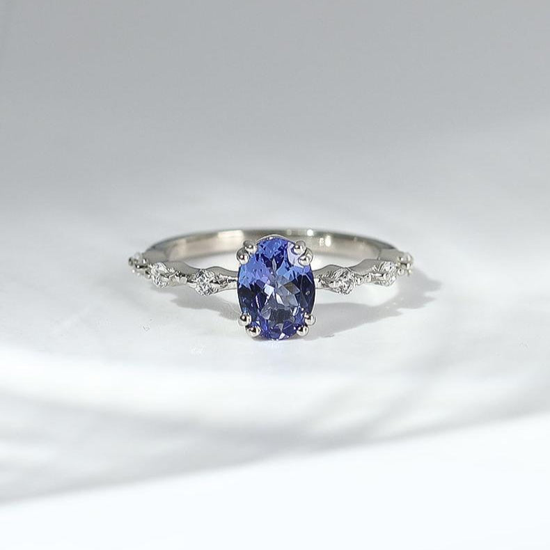 Elegant gemstone ring in sterling silver with intricate detailing.