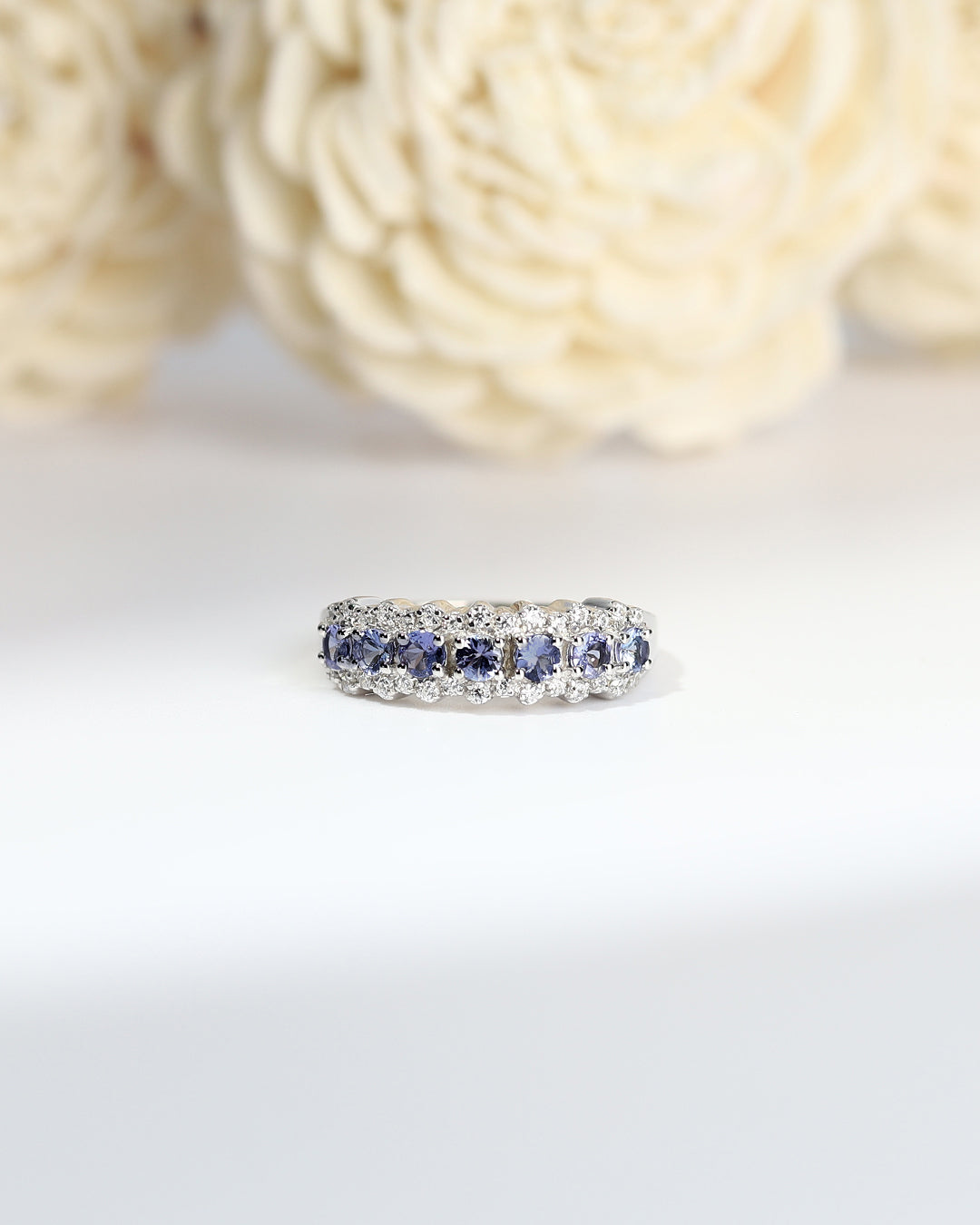 Elegant gemstone ring in sterling silver with intricate detailing.