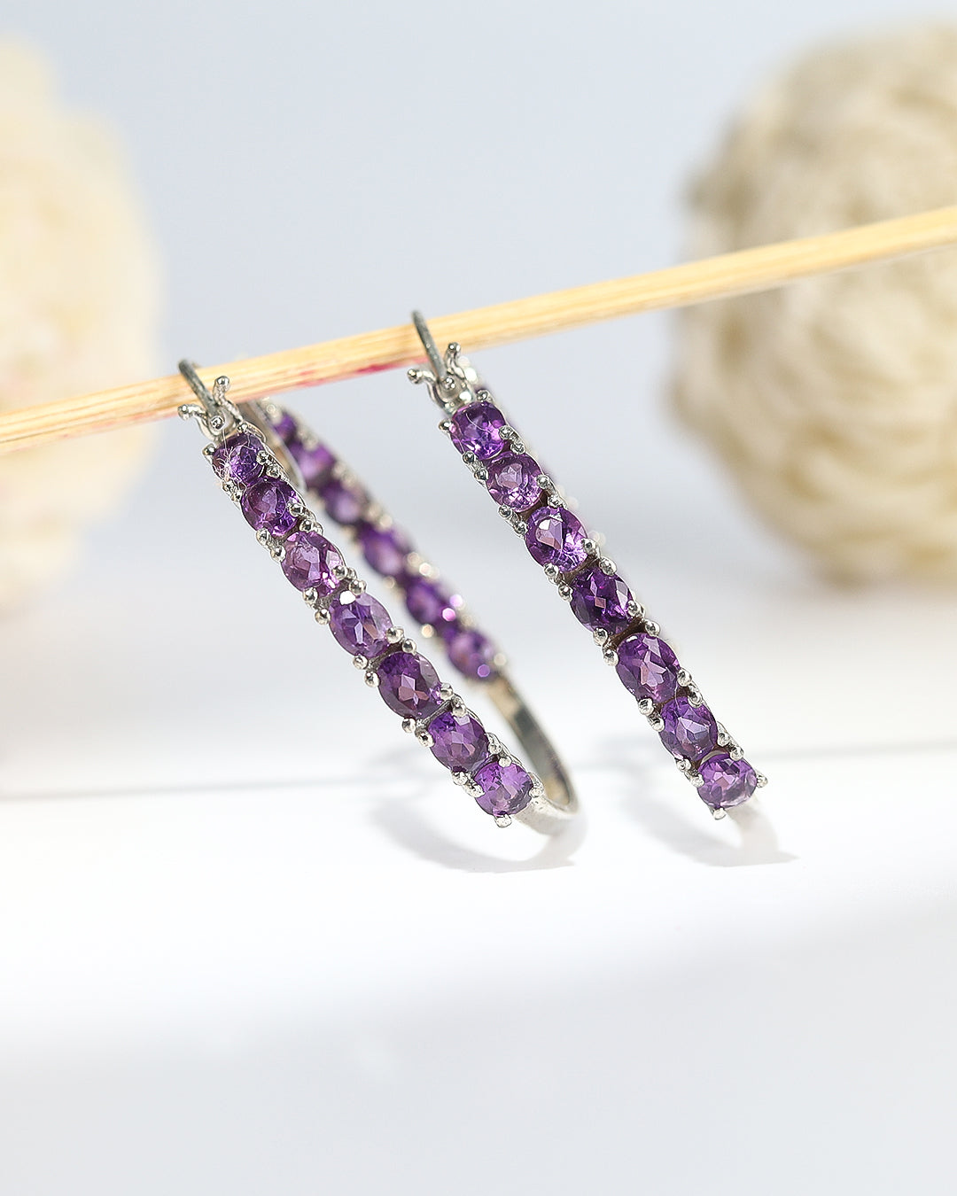 Dazzling hoop earrings featuring precious gemstones in a prong setting.